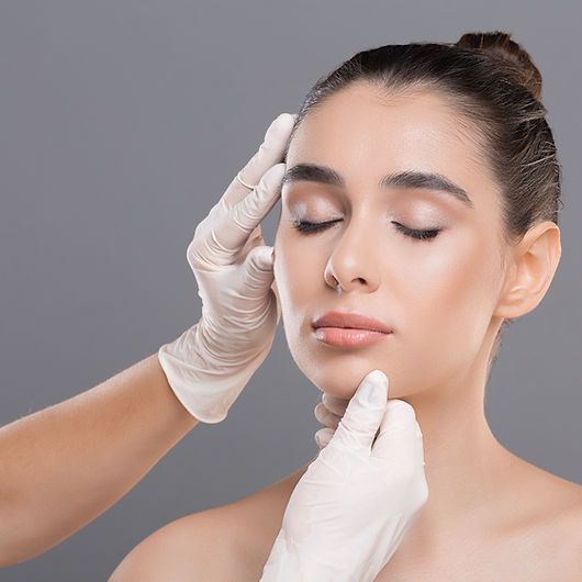 Skincare treatment with hands and gloves.