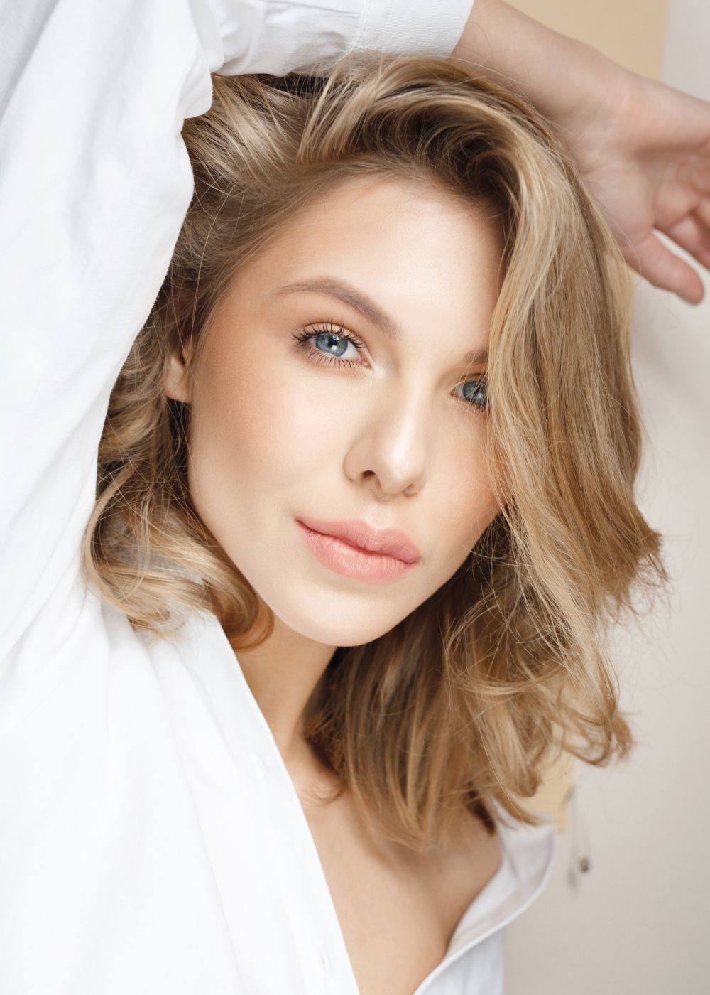 Close-up of a woman with tousled hair.